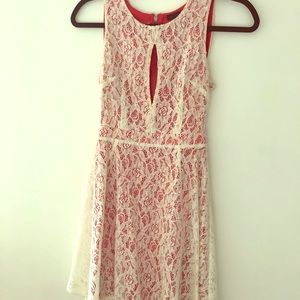 White lace cutout dress with pink underlay